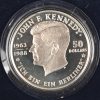 Drie verschillende munten waaronder één gouden van 10 gr. 250 dollar. Eén zilveren van 100 dollar 155,5 gr. 999,5‰ en één zilveren van 28,28 gr. 925‰. John F. Kennedy.