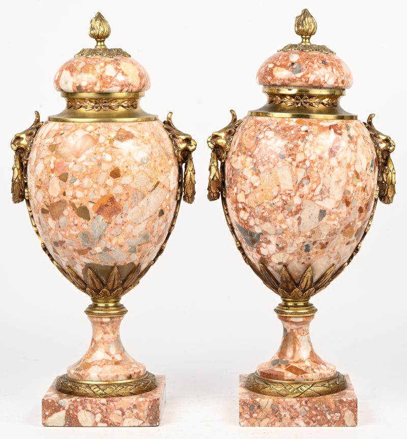 Een paar geaderd marmeren cassolettes met losse deksels versierd met verguld bronsbeslag en leeuwenkoppen.