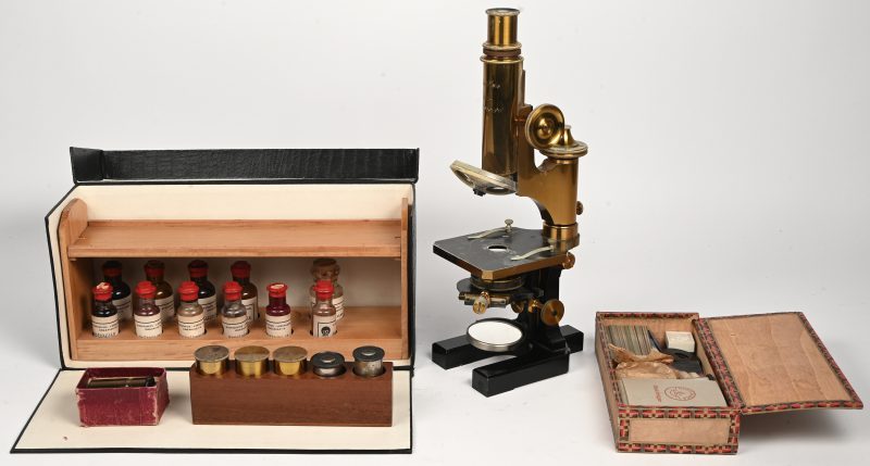 Een Carl Zeiss Jena microscoop, genummerd 11596 met bijhorend diverse lenzen, toebehoren en enkele chemicaliën.