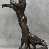 “Orpheus”. Een gepatineerd bronzen beeld van een schaars gekleede man met harp en aan diens voeten een poema. Onderaan gesigneerd.