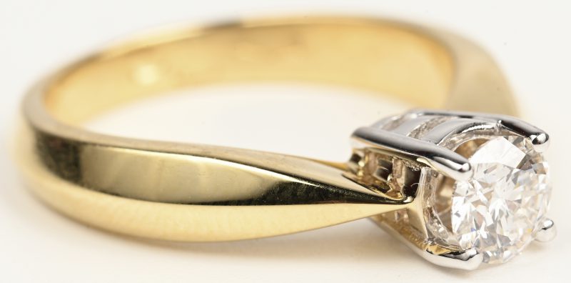 Een 18 kt wit en geelgouden ring bezet met centrale briljant van +- 0,51 ct. GVVS2.
