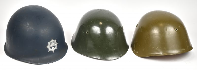 Een lot van drie helmen waarvan één Nederlandse MP helm en twee Bulgaarse M72 legerhelmen.