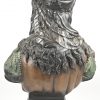 Een buste van een jonge vrouw met pluimhoed naar barok voorbeeld. Polychroom brons.