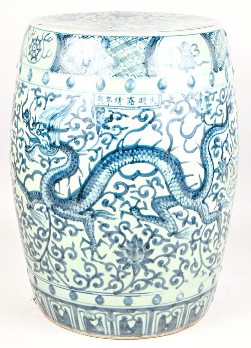 Een Chinees aardewerken tuinkruk, blauw-wit met draak en floraal decor.