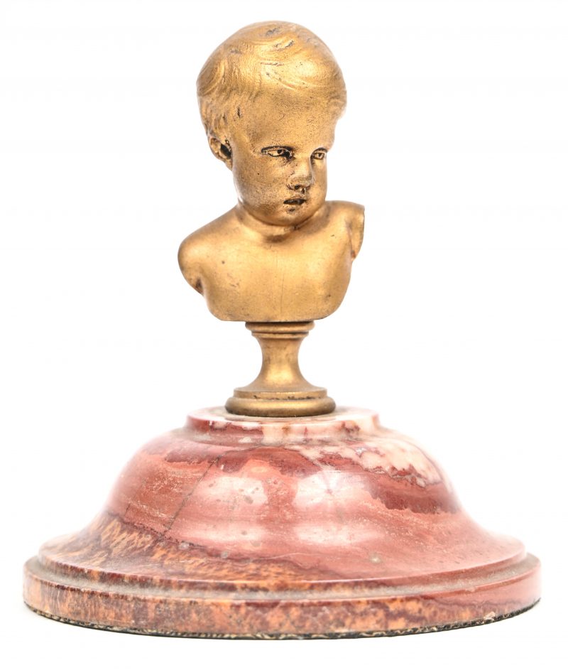 Een verguld bronzen buste van een kinderhoofje op marmeren voet. In de schouder gesigneerd.