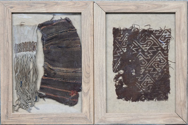 Een lot van 2 ingekaderde artefacten, waarvan 1 met een stukje Precolombiaans mummiestof, Chancay. En 1 met 2 stoffen Coca blad zakjes of Ch’uspa.