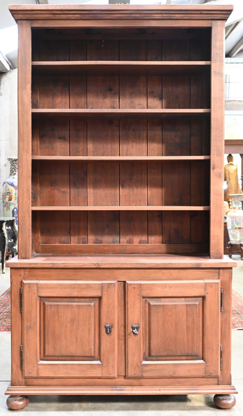 Een eikenhouten bibliotheekkast, landelijke stijl met 4 schabben en gesloten kastdeel onderaan.