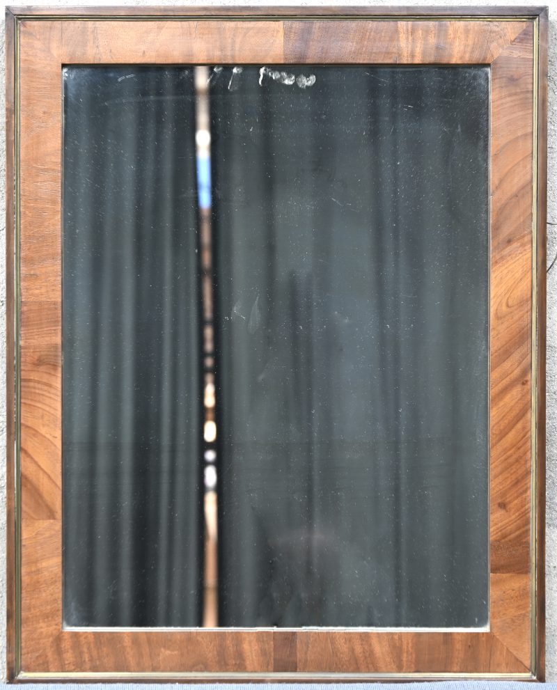Een oude spiegel in mahonie gefineerde kader.