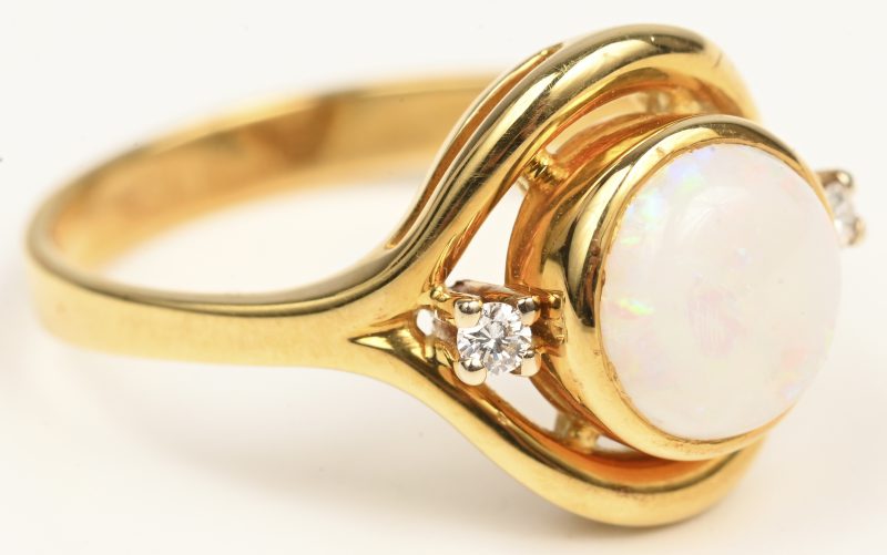 Een 18 kt geelgouden ring bezet twee briljantjes en opaal.