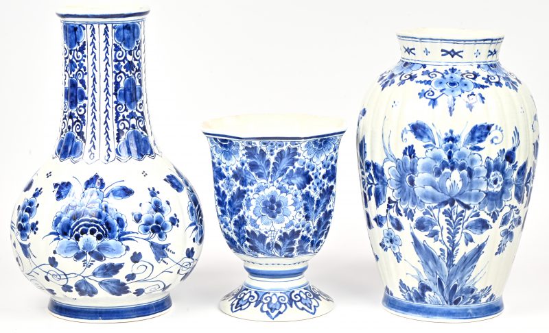 Een lot van drie vazen blauw en wit aardewerk met floraal decor. Gemerkt De Porceleyne Fles. 1 met rand schilfer.