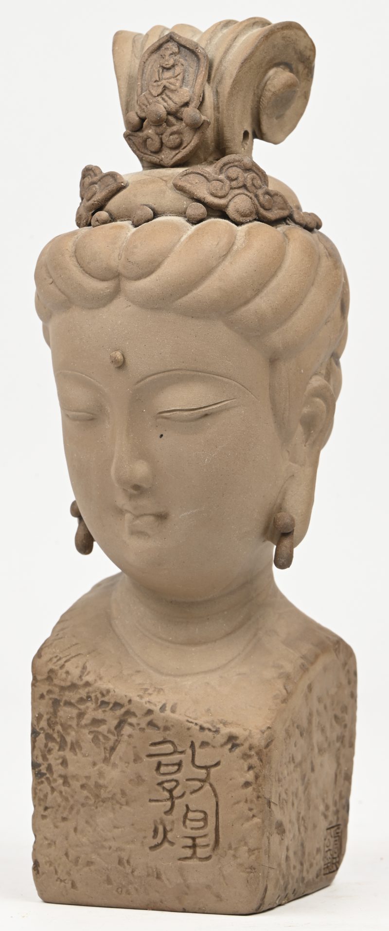 Een terracotta Boeddha buste in doosje met gestoffeerd oppervlak.