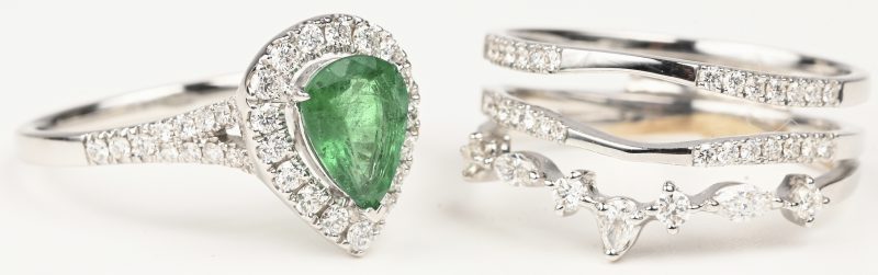 Een 18 kt witgouden dubbele ring bezet met briljanten met een gezamenlijk gewicht van +- 0,80 ct. en een drubbelvormige smaragd van +- 0,80 ct. Mer certificaat.