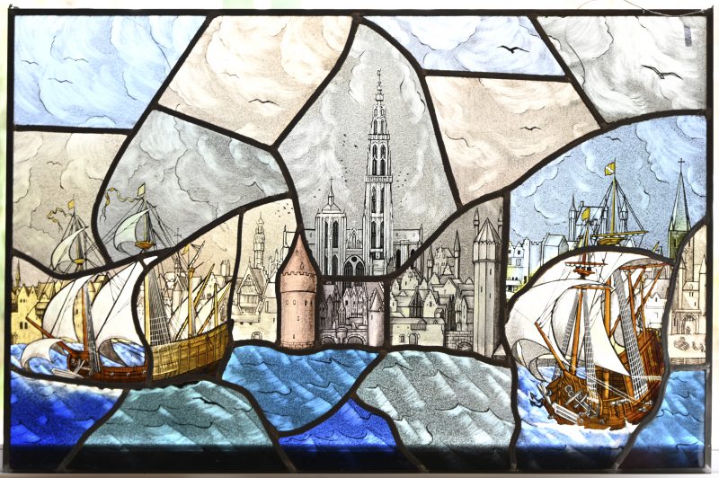 Een groot glas in loodraam met een zicht vanop linkeroever op schepen en de stad Antwerpen, Draagt een monogram links onder.