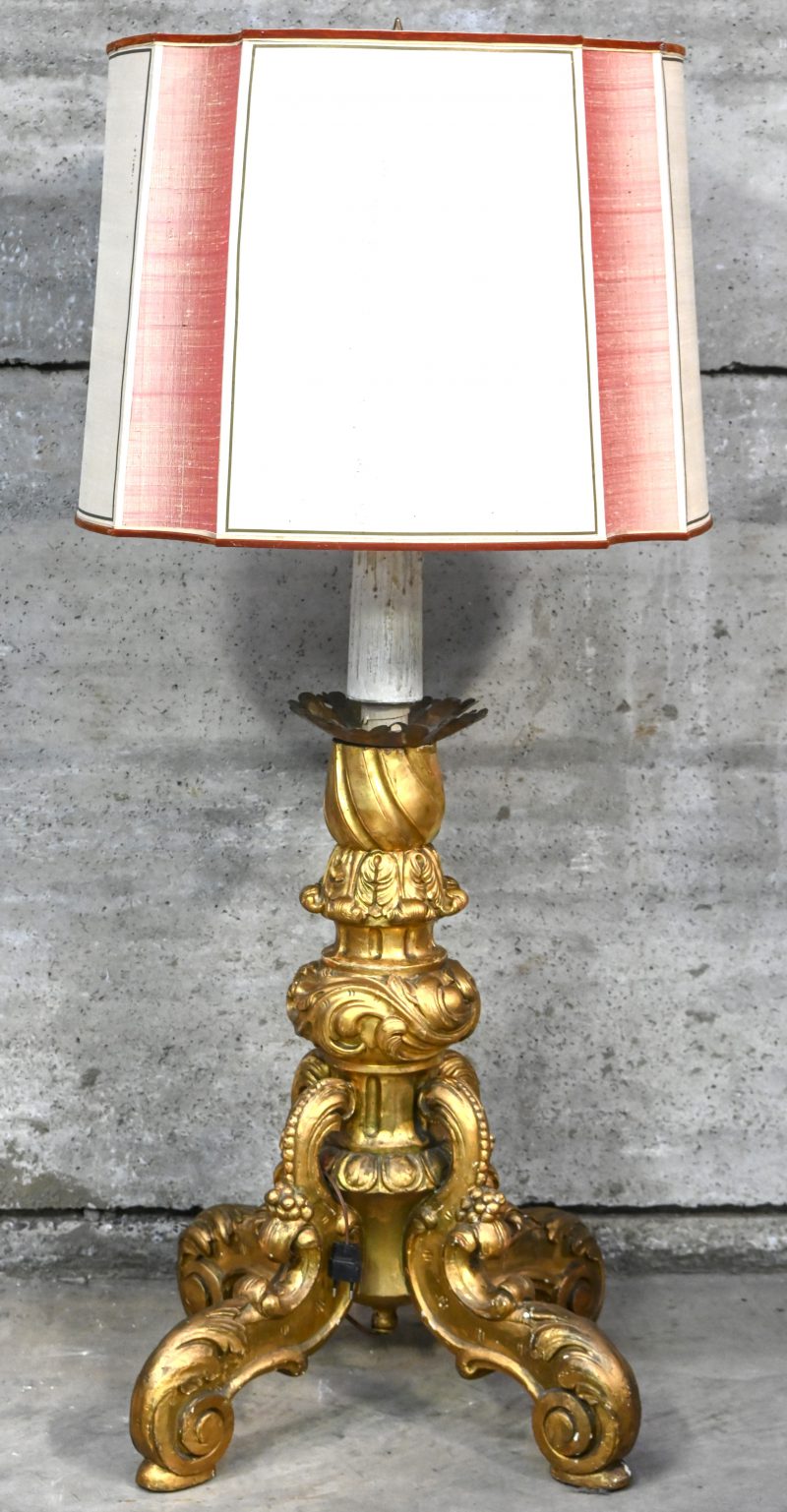 Een staande lamp met vergulde houtgesculpteerde voet.