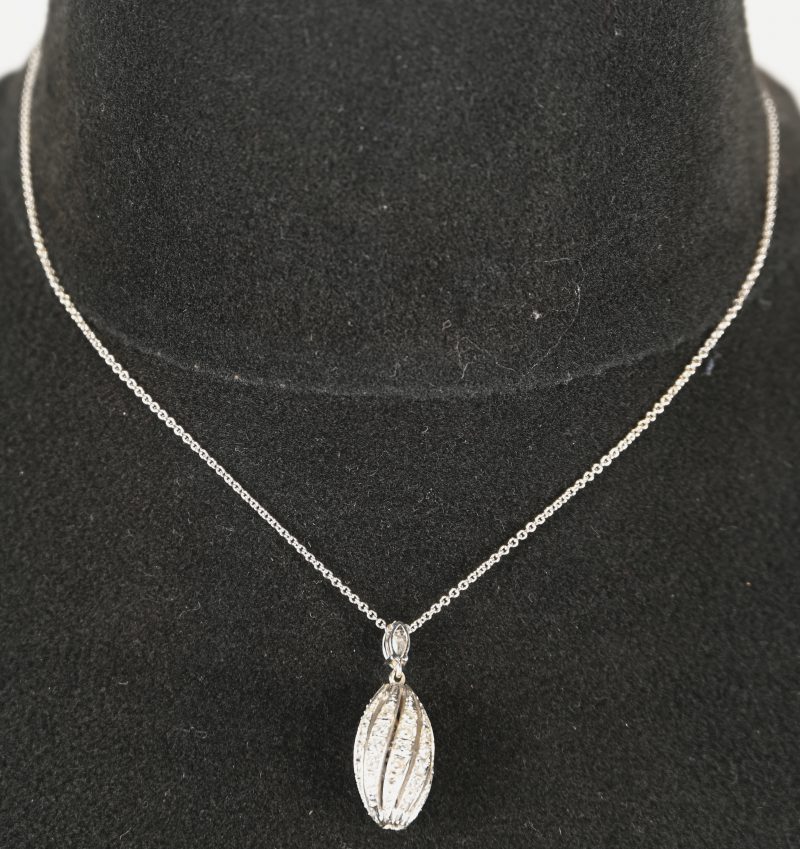 Een 18 kt witgouden ketting met hanger bezet met één diamant markies geslepen van +- 0,40 ct. en diamanten met een gezamenlijk gewicht van +- 0,90 ct.