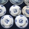 Een lot porselein en zachte pasta met diverse blauw en witte decors. Baudour, Boch enz. Met koppen en schoteltjes, doosje borden en schotels.