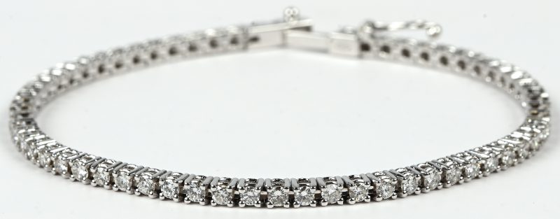 Een 18 kt witgouden tennisarmband  bezet met briljanten met een gezamenlijk gewicht van +- 2,44 ct. FVS-VVS.