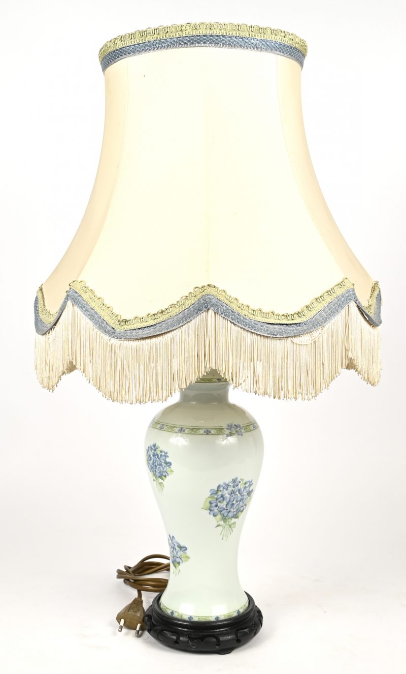 Klassieke tafellamp op porceleinen vaas met bloemendecor.