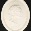 Een paar ovalen wandmedaillons in wit marmer, met in bas-reliëf de beeltenis van keizers Augustus en Julius.