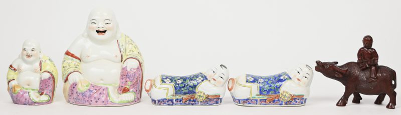 Een lot van vier beeldjes van Chinees porselein. Twee lachende Boeddha’s, twee liggende vrouwenfiguren. Toegevoegd, een houten beeldje van een lezend kind op een waterbuffel.