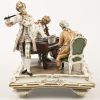 “Muzikanten”, een porseleinen groep met een pianist, een fluitist en een cellist. Strijkstok van de cellist manco. Gemerkt.