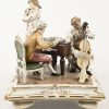 “Muzikanten”, een porseleinen groep met een pianist, een fluitist en een cellist. Strijkstok van de cellist manco. Gemerkt.