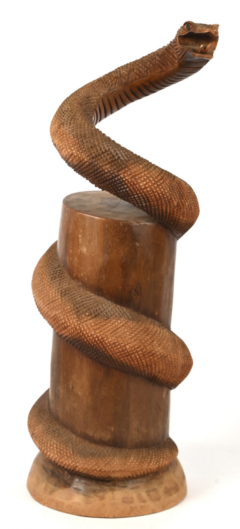 Een gesculpteerd houten beeld van een slang, stijgend rond een boom.