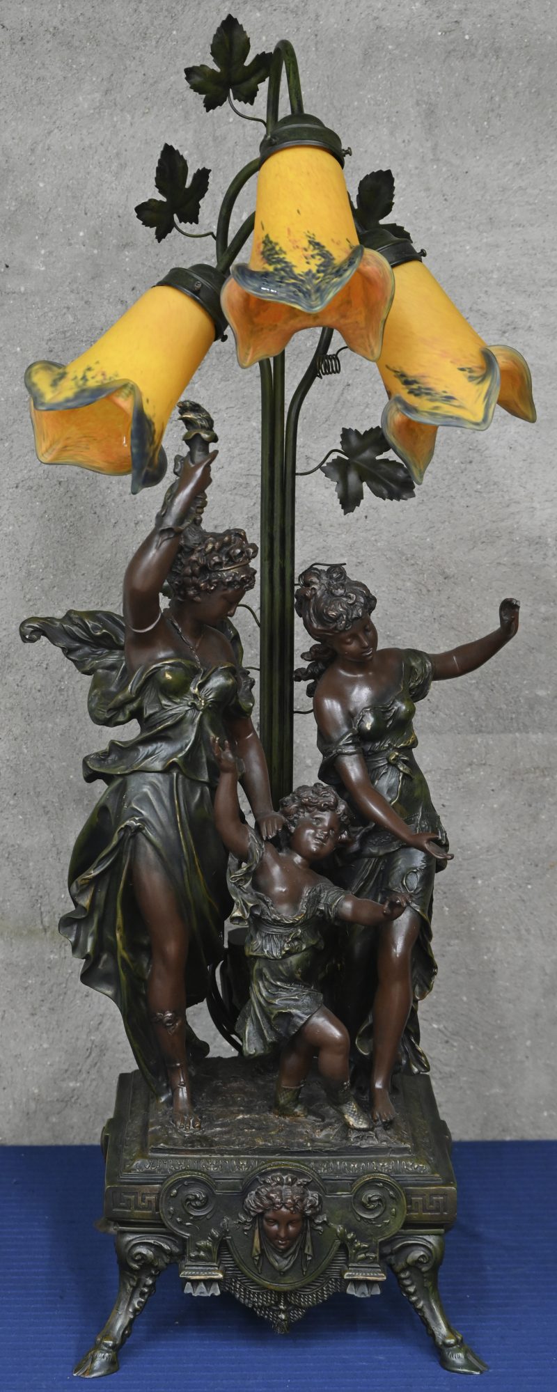 Een tafellamp met kunststoffen groep en glazen blakers gemerkt Art France. 2 vingers afgebroken maar erbij.