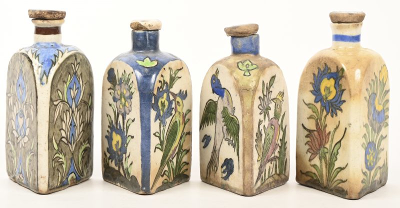Een lot van 4 meerkleurig aardewerken Perzische Iznik flesjes gedecoreerd met bloemen en vogels.