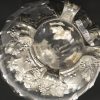Een kristallen karaf, gemerkt Cristal St. Louis France, met tinnen druivenranken, deksel en voetjes.