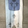 Een lot van 2 vaandels met heraldische symbolen en een ridder te paard