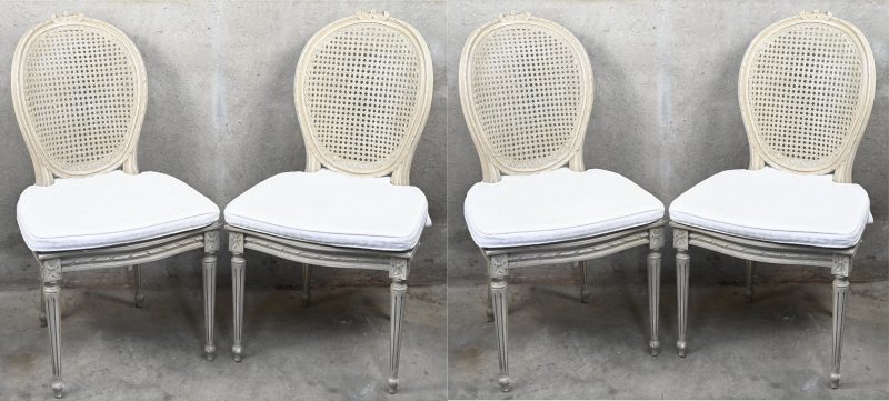 Een set van vier gepatineerde stoelen in Louis XVI stijl. Met cannage rug en zit en bijpassende kussens.