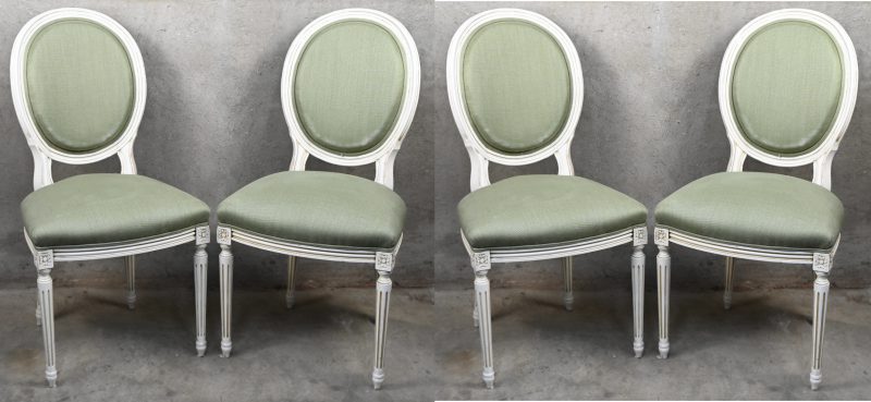 Een ronde verlengbare tafel met vier stoelen in Louis-Philippe stijl. De stoelen zijn licht gepatineerd met olijfgroene bekleding. De tafel heeft een beetje schade aan het blad.