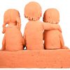 Een terracotta groep voorstellend 3 gezeten kinderen, gesigneerd May Claerhout.