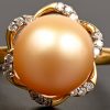 Een 18 kt geelgouden ring bezet met briljanten met centrale parel en briljanten met een gezamenlijk gewicht van 0,20 ct.