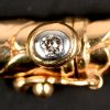 Een 18 kt geelgouden gevlochten halssnoer met een briljant van +- 0,05 ct. aan het slotje.