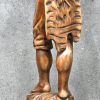 ‘Herdersjongen met mand’, een massief houten beeld.