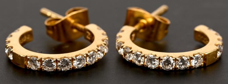 Een paar 18 kt geelgouden oorbellen bezet met briljanten met een gezamenlijk gewicht van +- 0,30 ct.