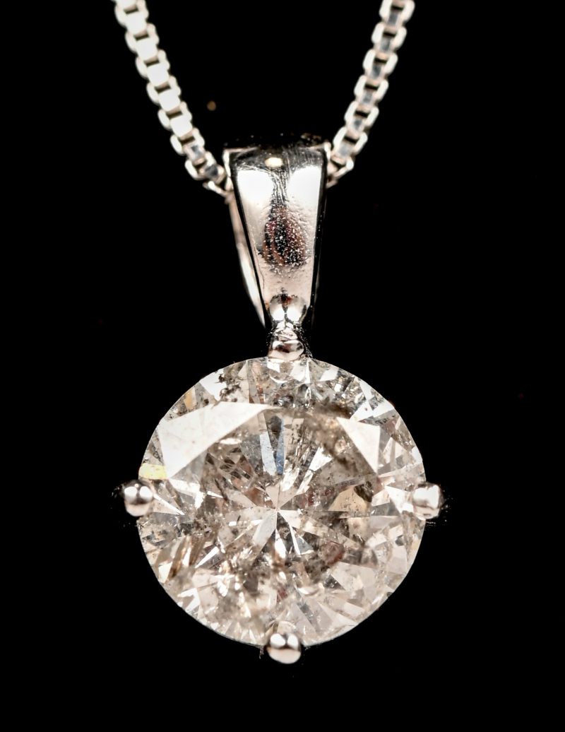 Een 18 kt witgouden ketting met hanger bezet met een diamant van +- 1