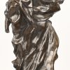 Een plaasteren beeld met bronspatina in religieus thema. Herstelling aan de voetjes.