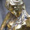 Een bronzen zeemeermin met een grote gouden parel in schelp. Getekend; Zache, Diseno, Spain. Onderstel van een salontafel, blad is manco.