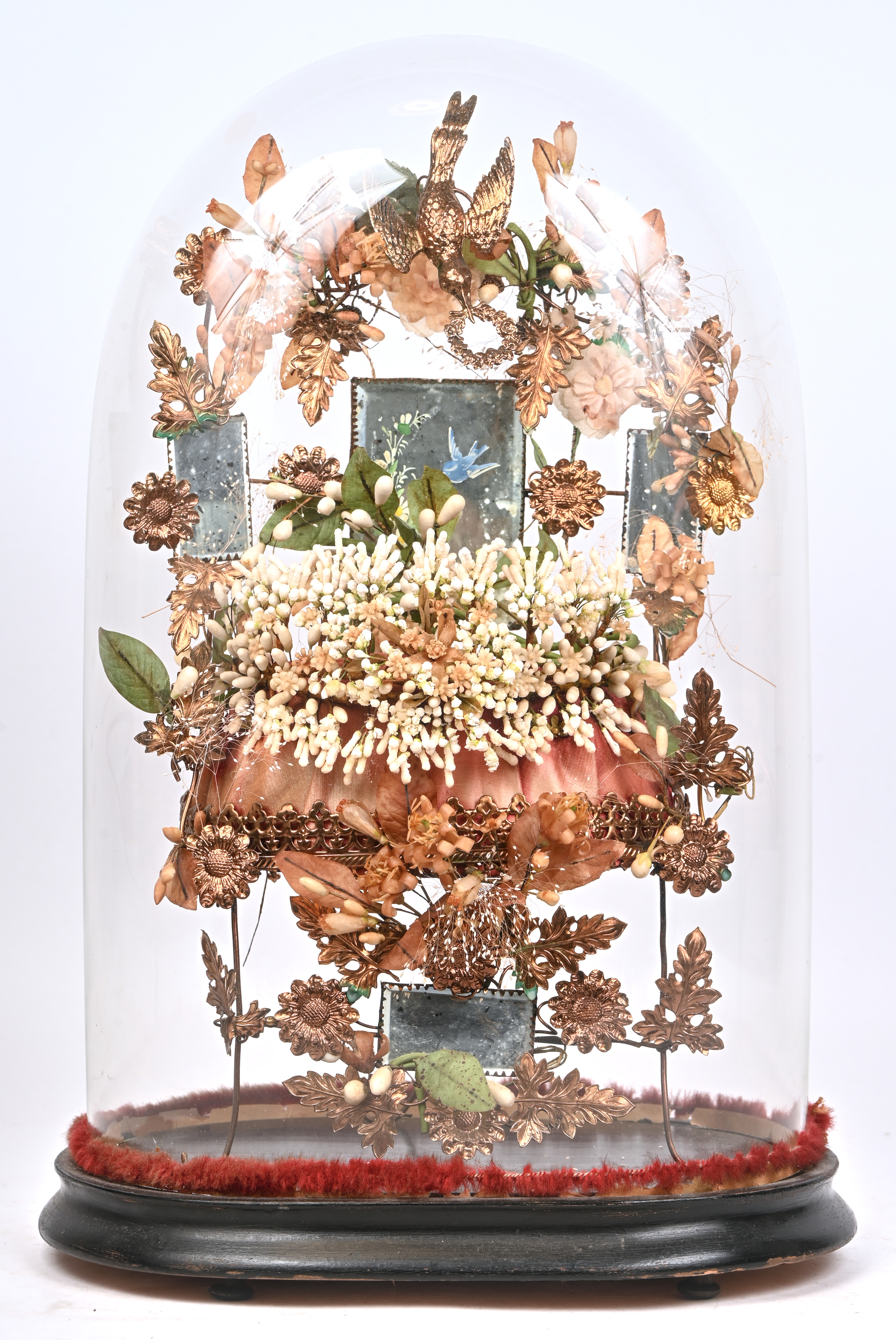 Een oude decoratieve stolp met een rijkelijk versierd stoeltje. Van metaal en beschilderde spiegeltjes gedecoreerd met bloemen en een goudkleurige spreeuw Een oude decoratieve stolp met een rijkelijk versierd stoeltje. Van metaal en beschilderde spiegeltjes gedecoreerd met bloemen en een goudkleurige spreeuw.