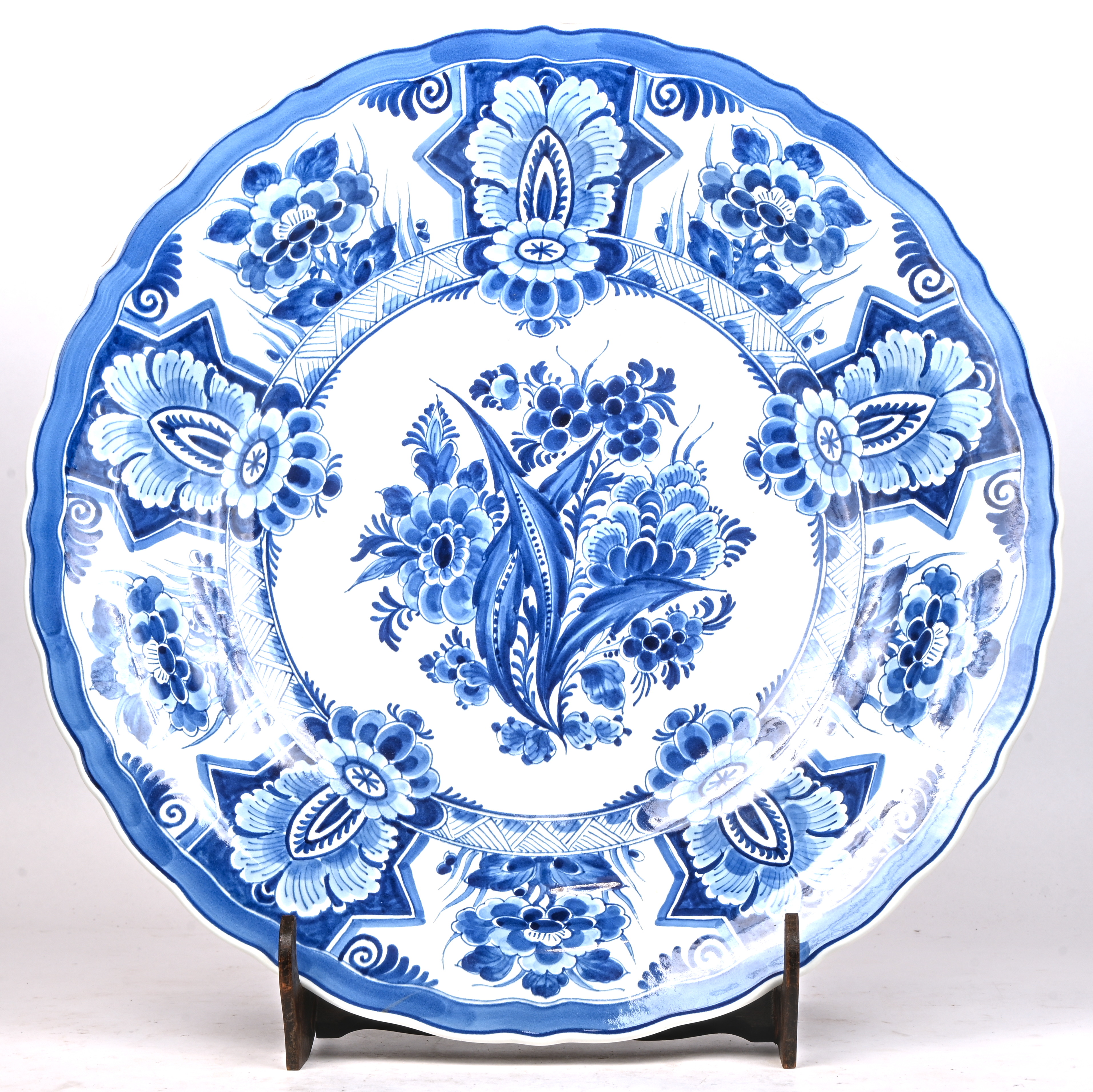 Een grote Delfts aardewerken sierschotel, gemerkt De Porseleyne Fles Een grote Delfts aardewerken sierschotel, gemerkt De Porseleyne Fles.