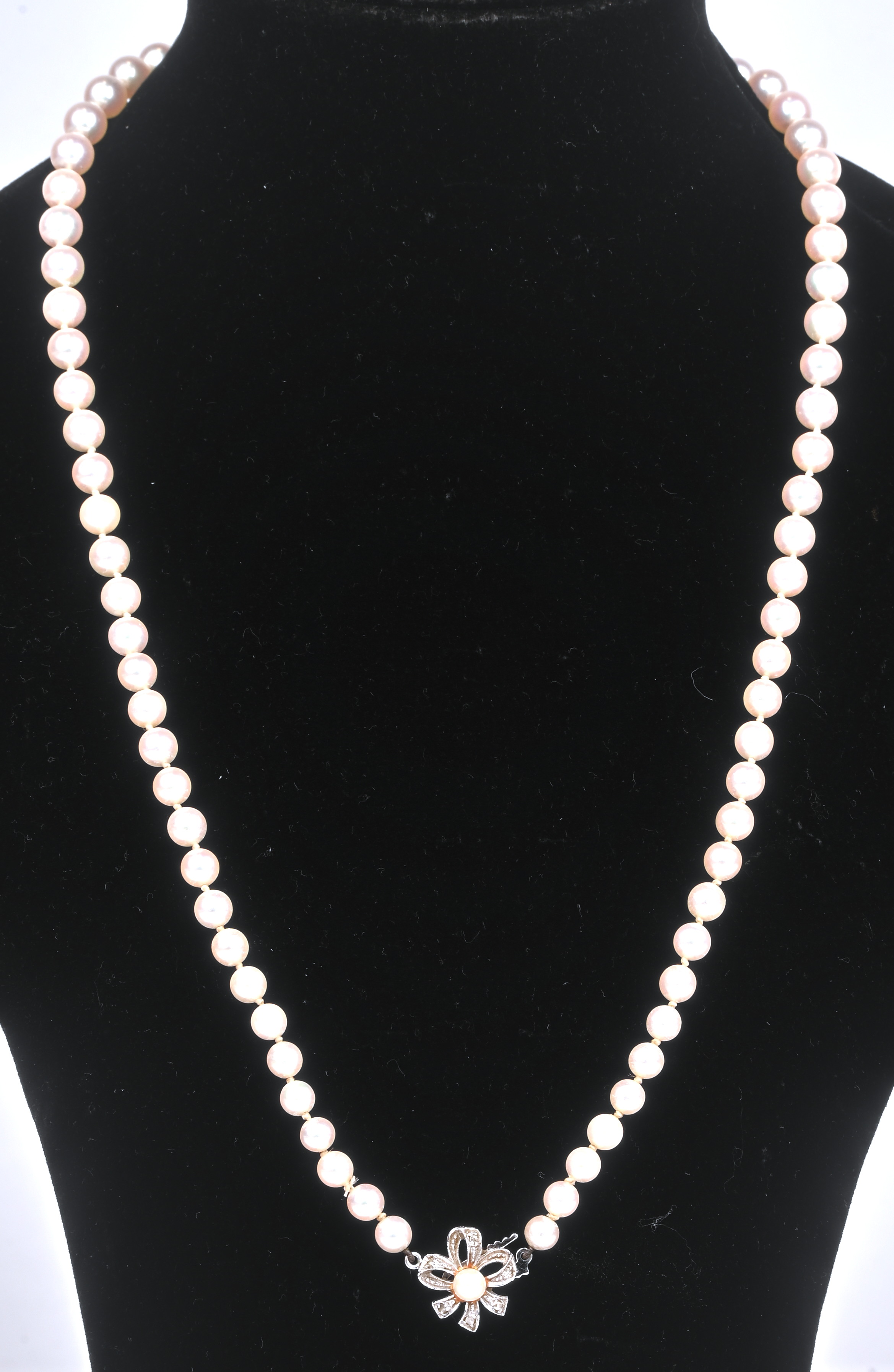 Een parelhalssnoer met 18 kt witgouden bloemvormig slot bezet met zes diamantjes oude slijp Een parelhalssnoer met 18 kt witgouden bloemvormig slot bezet met zes diamantjes oude slijp.