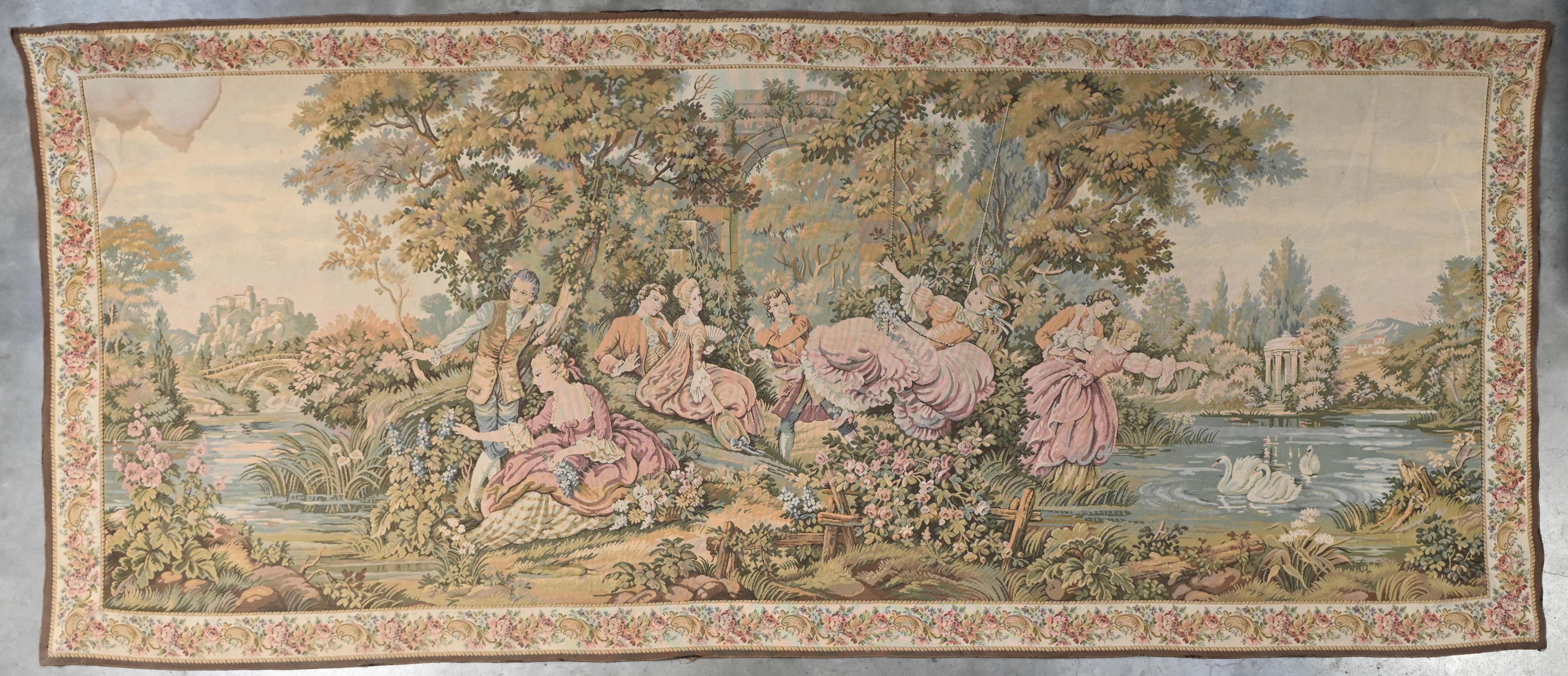 Een wandtapijt met een decor van verliefde koppeltjes in een landschapstuin, naar de 18e eeuw. Met waterschade aan de linkerbovenhoek. Draagt achteraan een label ‘DAL 1925’ Een wandtapijt met een decor van verliefde koppeltjes in een landschapstuin, naar de 18e eeuw. Met waterschade aan de linkerbovenhoek. Draagt achteraan een label ‘DAL 1925’.