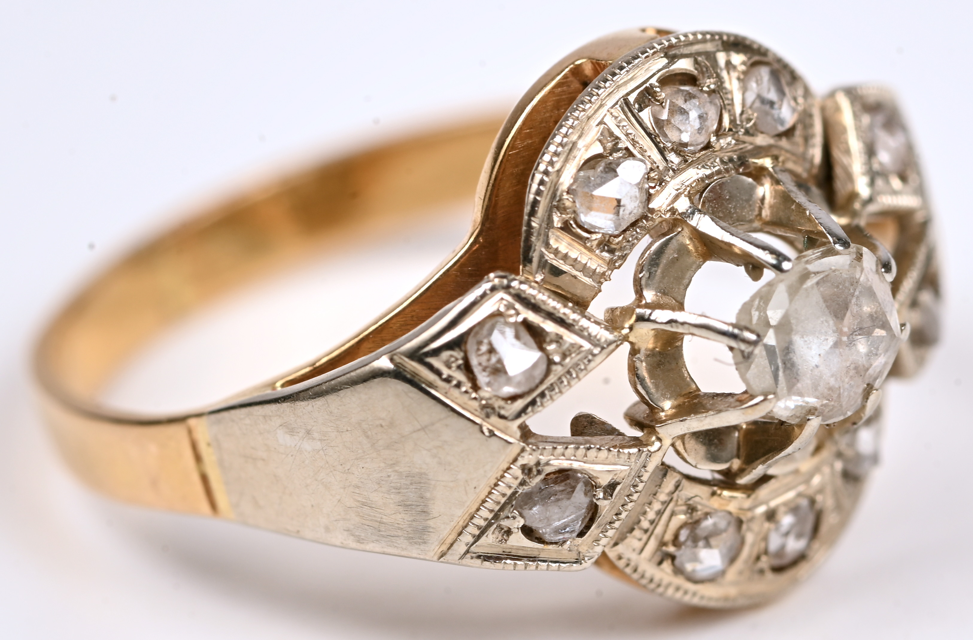 Een 18 kt wit en geelgouden art nouveau ring bezet met diamanten oude slijp met een gezamenlijk gewicht van +- 0,30 ct Een 18 kt wit en geelgouden art nouveau ring bezet met diamanten oude slijp met een gezamenlijk gewicht van +- 0,30 ct.
