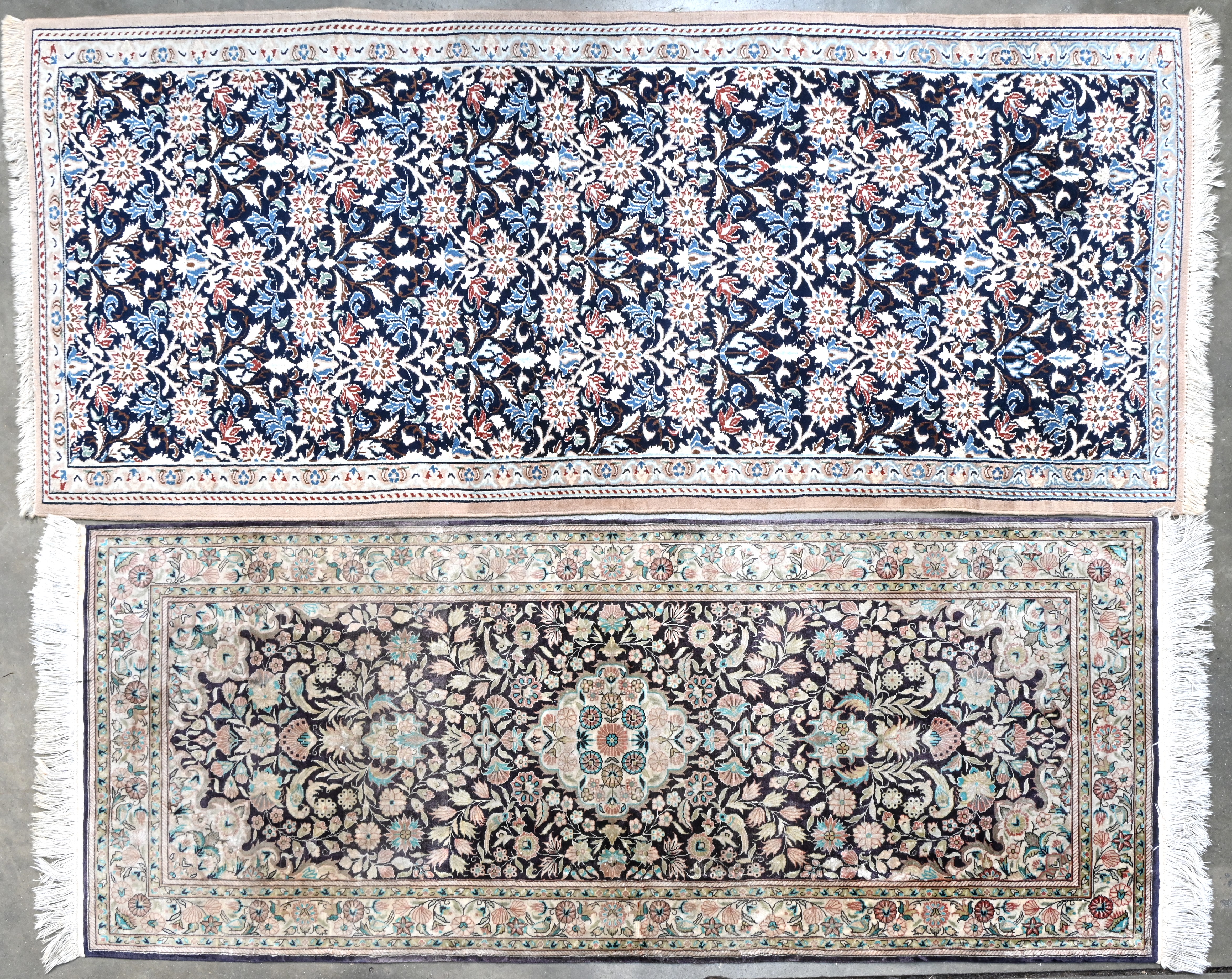 Een paar Iraans handgeknoopt zijden tapijtjes Een paar Iraans handgeknoopt zijden tapijtjes.