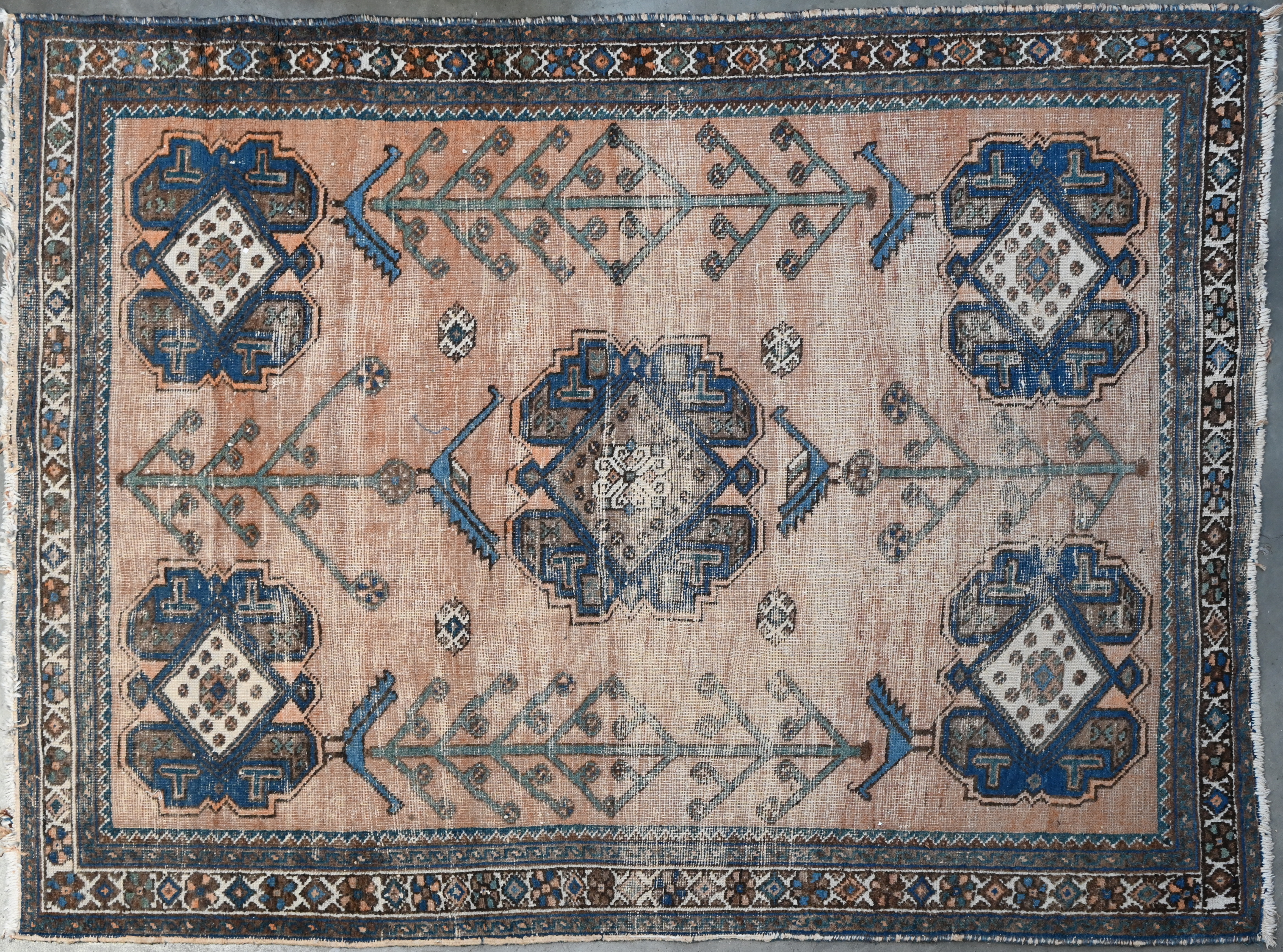 Een handgeknoopt tapijt met slijtage Een handgeknoopt tapijt met slijtage.