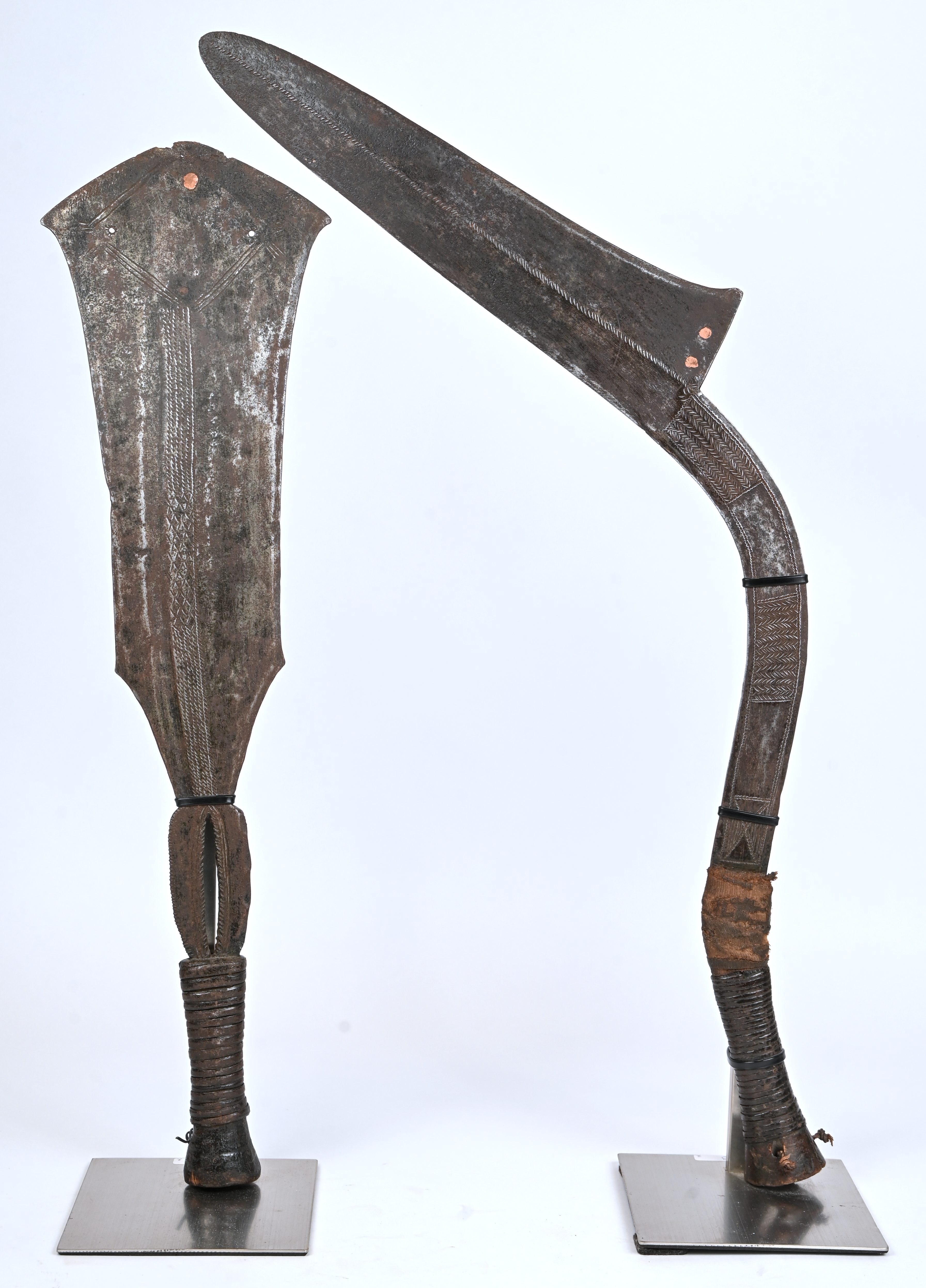 Twee traditionele Afrikaanse wapens. Een Azande zwaard en een Konda machette Twee traditionele Afrikaanse wapens. Een Azande zwaard en een Konda machette.