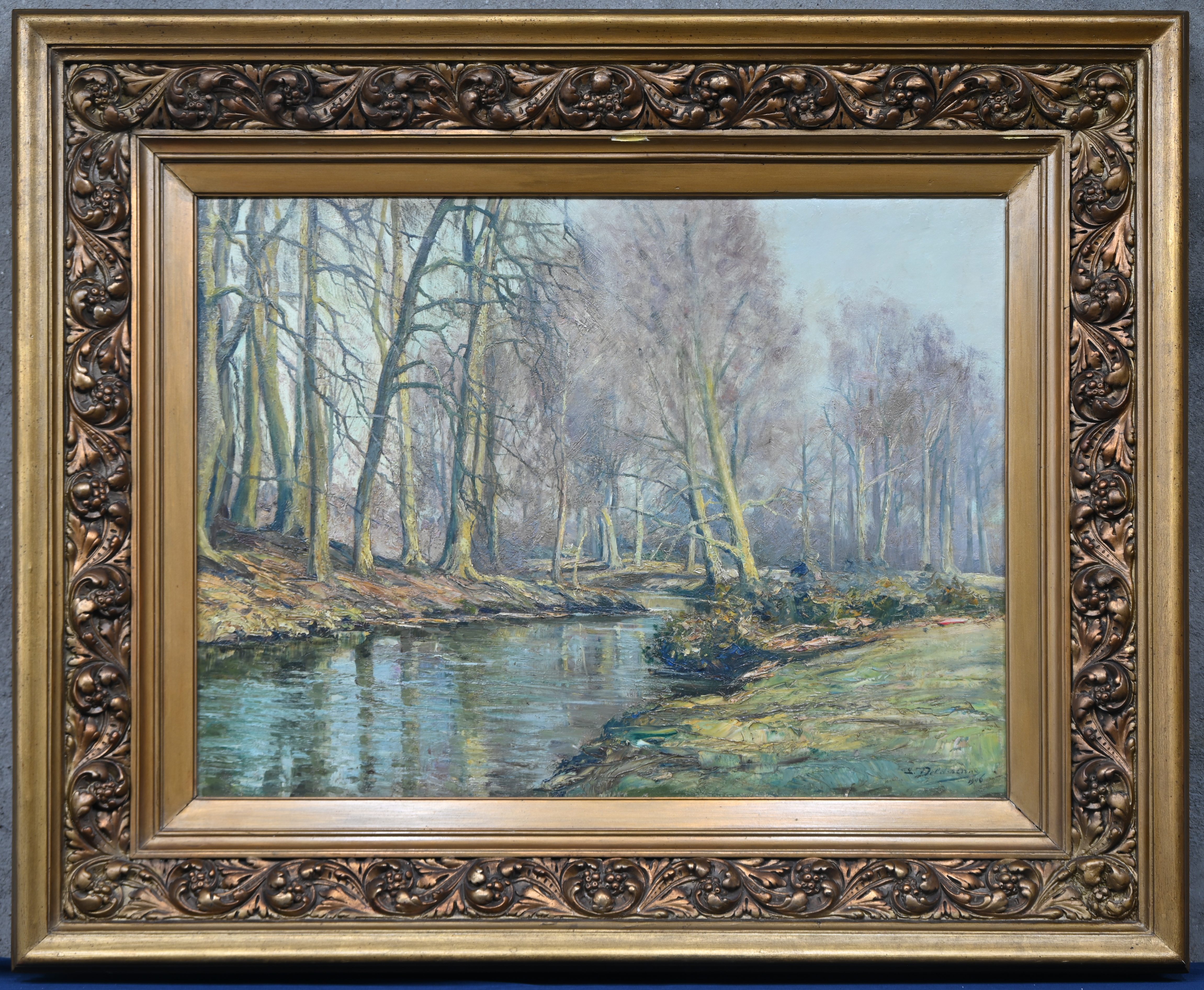 ‘Landschap met beek’, een olieverfschilderij op doek. Getekend L. Delderenne, 1906 ‘Landschap met beek’, een olieverfschilderij op doek. Getekend L. Delderenne, 1906.
